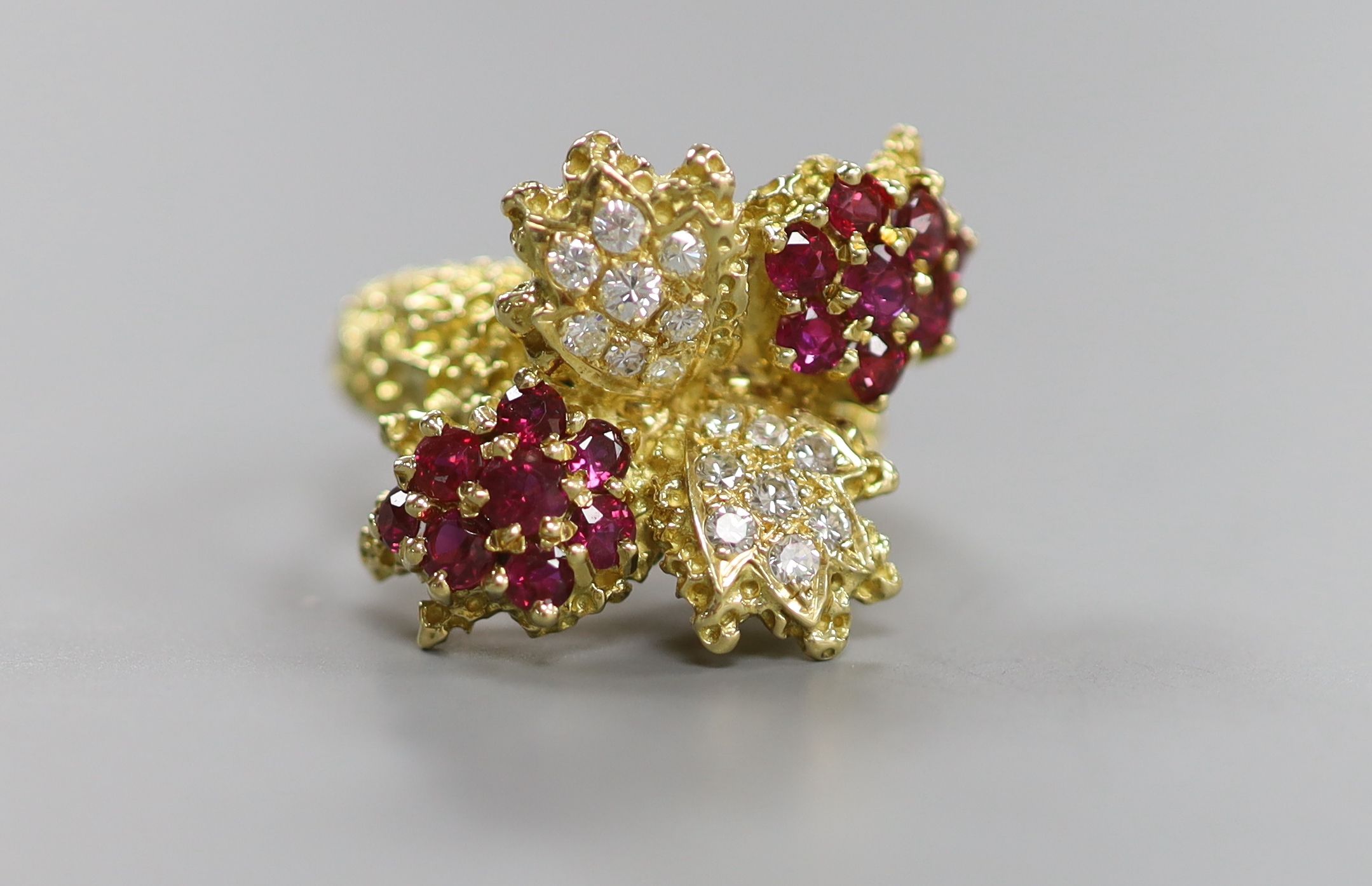 A 1970's 18ct gold, ruby and diamond quadruple cluster dress ring, by Ben Rosenfeld